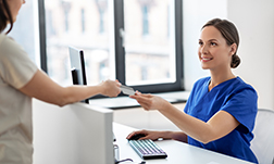 medicine, people and healthcare concept - happy smiling female doctor or nurse and patient with insurance or credit card card at hospital